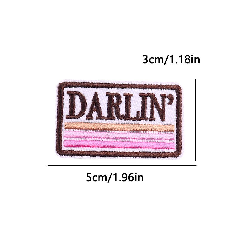Embroidered patch with the word DARLIN in brown and pink thread.