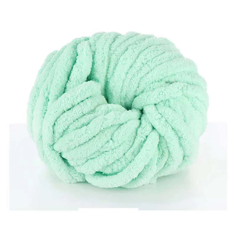 A ball of light mint green hand-woven chunky chenille yarn.