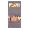 A gray storage case holds an aluminum circular needle set and a piece of paper.