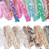A close-up of various crystal rhinestone sticker ribbon rolls in pink, purple, teal, and green colors.