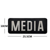 Black media name patch embroidered with silver text and hook and loop backing