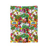 A colorful fabric throw blanket featuring a pattern of cartoonish green and yellow characters and gifts.
