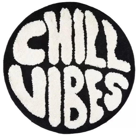 Black and white fuzzy round floor mat with the text CHILL VIBES in a distressed letter pattern