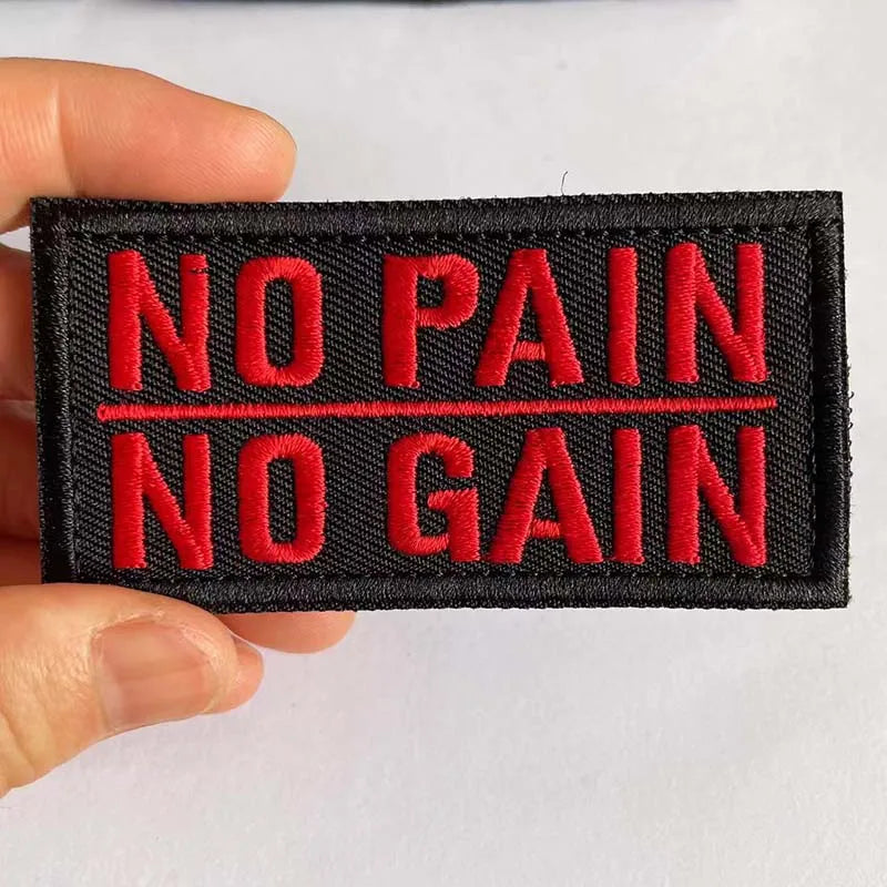 Black embroidered patch with red text reading NO PAIN NO GAIN