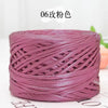 A spool of metallic purple cake yarn used for crafting.