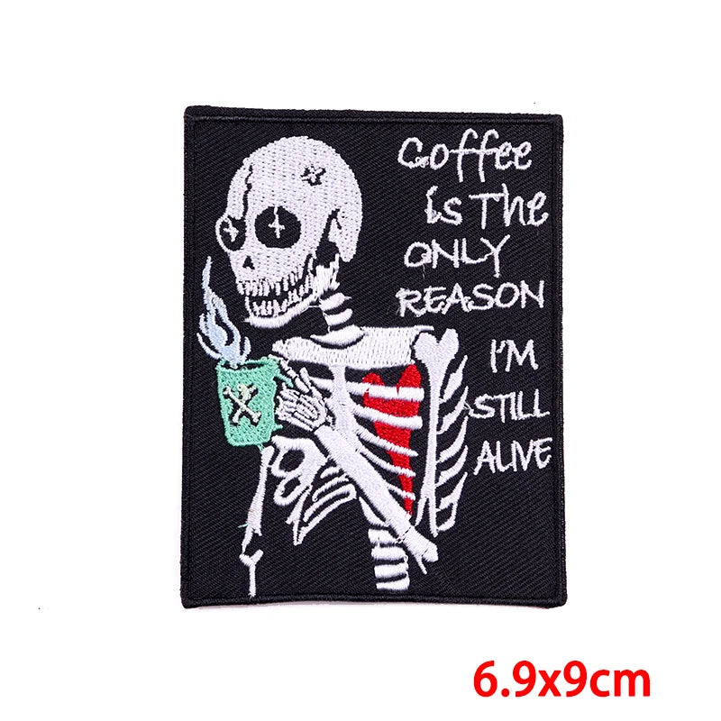 Black embroidered patch featuring a skull design with text that reads Coffee is the only reason I'm still alive