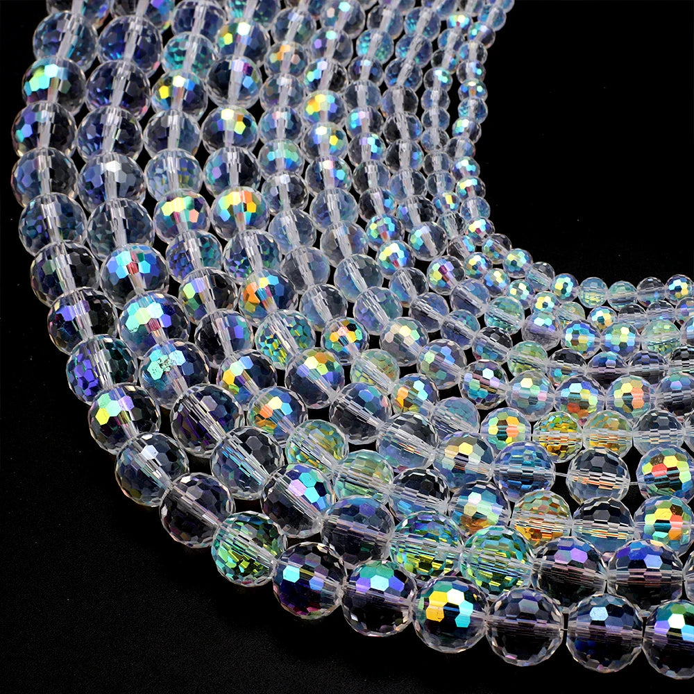 A close-up of multi-size shiny AB crystal glass beads arranged in a strand for jewelry making