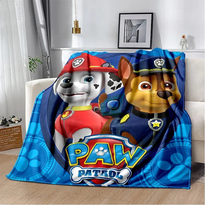 A colorful Paw Patrol cartoon blanket featuring Chase and Skye characters.