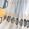 Light blue sheer gauze curtain with gold embroidery and blue accents