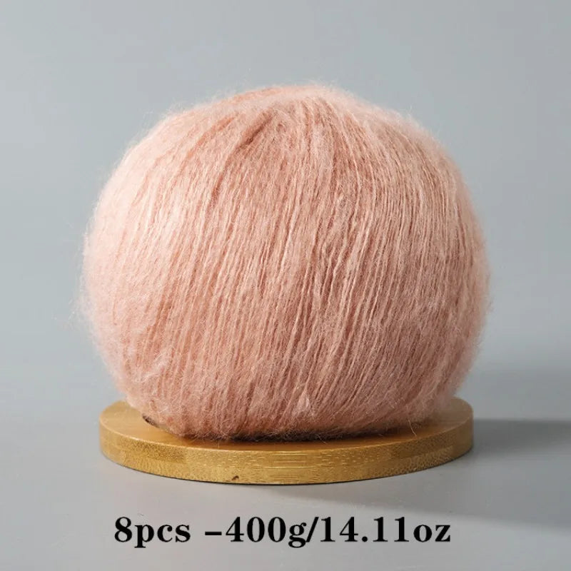 A ball of pink mohair yarn used for crafting.