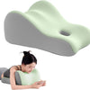 A light green memory foam wedge pillow is shown next to a person using it for support.