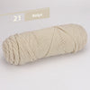 A skein of beige premium worsted cotton yarn is shown rolled up, displaying a chevron knit pattern.