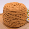 A ball of tan craft yarn made from 100% polyester, coiled and ready for knitting or DIY projects.