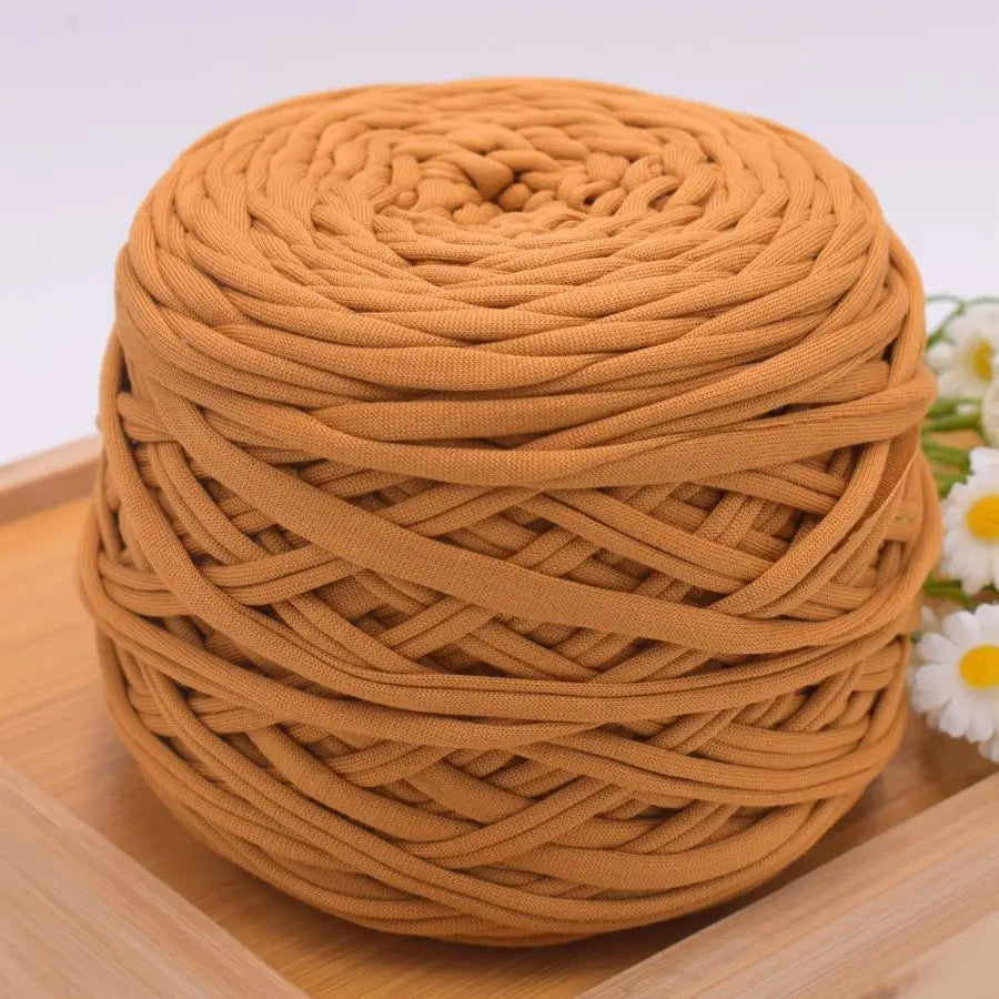 A ball of tan craft yarn made from 100% polyester, coiled and ready for knitting or DIY projects.