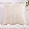 A cream-colored throw pillow cover featuring a geometric Greek key pattern embroidery on a white background.