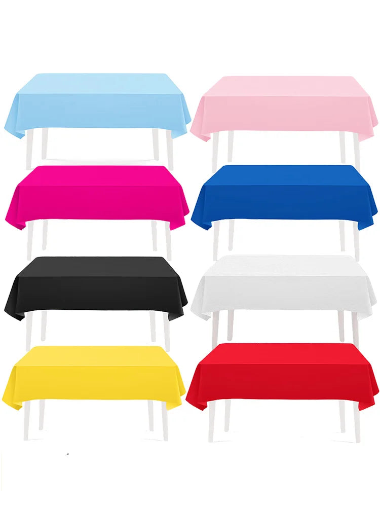 A collection of vibrant solid color rectangle tablecloths in blue, pink, magenta, black, white, yellow, and red.
