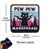 Black woven label patch featuring a cat silhouette and text that reads Pew Pew Madafakas!