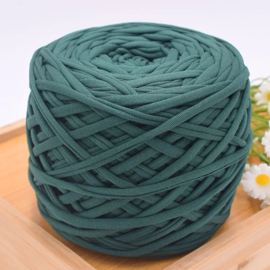 A ball of teal green craft yarn used for knitting and DIY projects.