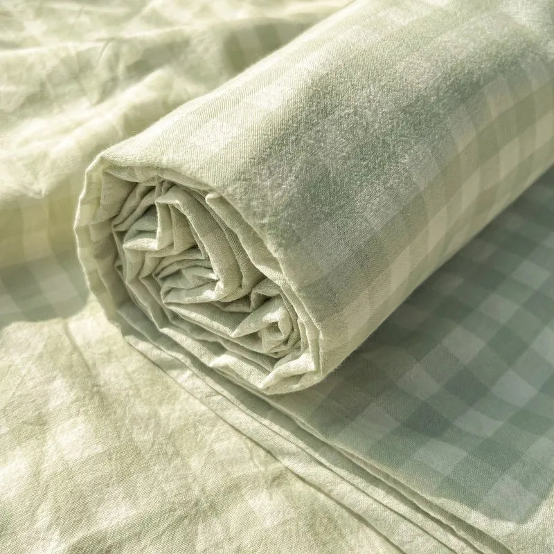 Rolled light beige organic cotton bedding set featuring a subtle plaid pattern.