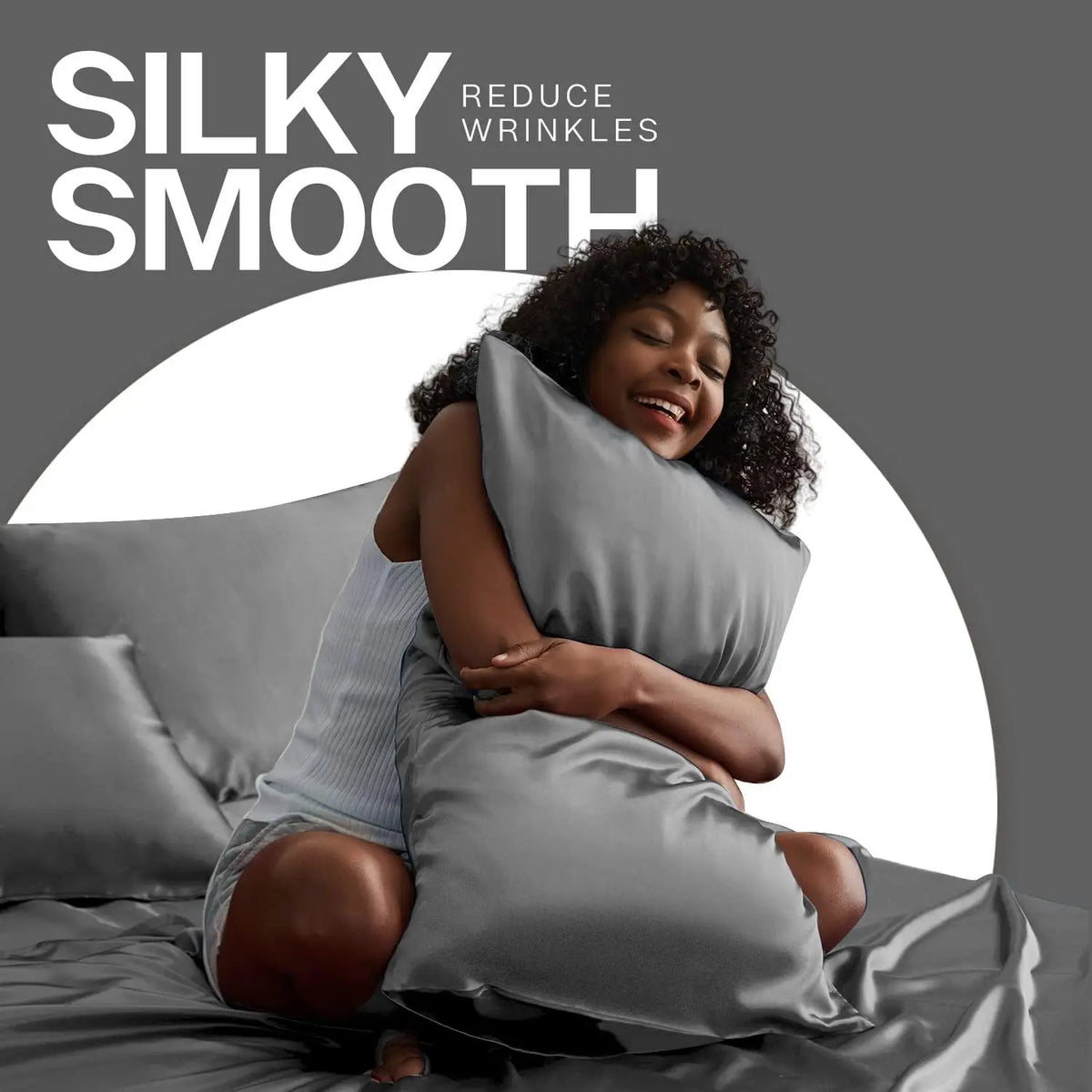 A woman with curly hair is relaxing on a bed, holding a satin pillowcase, with text promoting silky smooth skin.