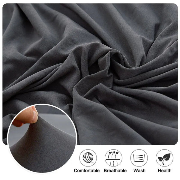 Close-up of a dark gray fabric showing the texture and drape of a sofa cushion protector cover.