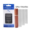A package containing 12 assorted self-threading stainless steel sewing needles and a wooden box.