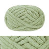 A ball of hand-knitted wool finger line scarf in a light sage green color.