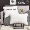 White faux fur pillow covers displayed on a gray sofa with a white rug and a potted plant.