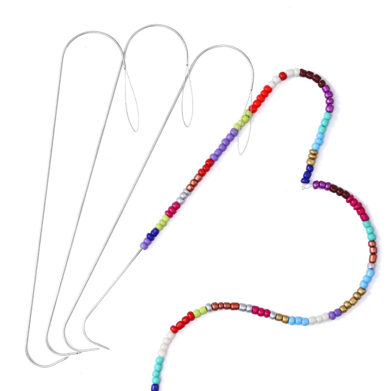 A set of precision beading needles with colorful threads arranged in a heart shape for DIY jewelry making