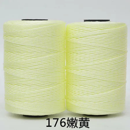 Two spools of light yellow hand knitting and crochet cord for crafting