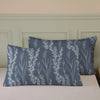 A set of three botanical print duvet covers and pillowcases in blue-gray with white floral designs.