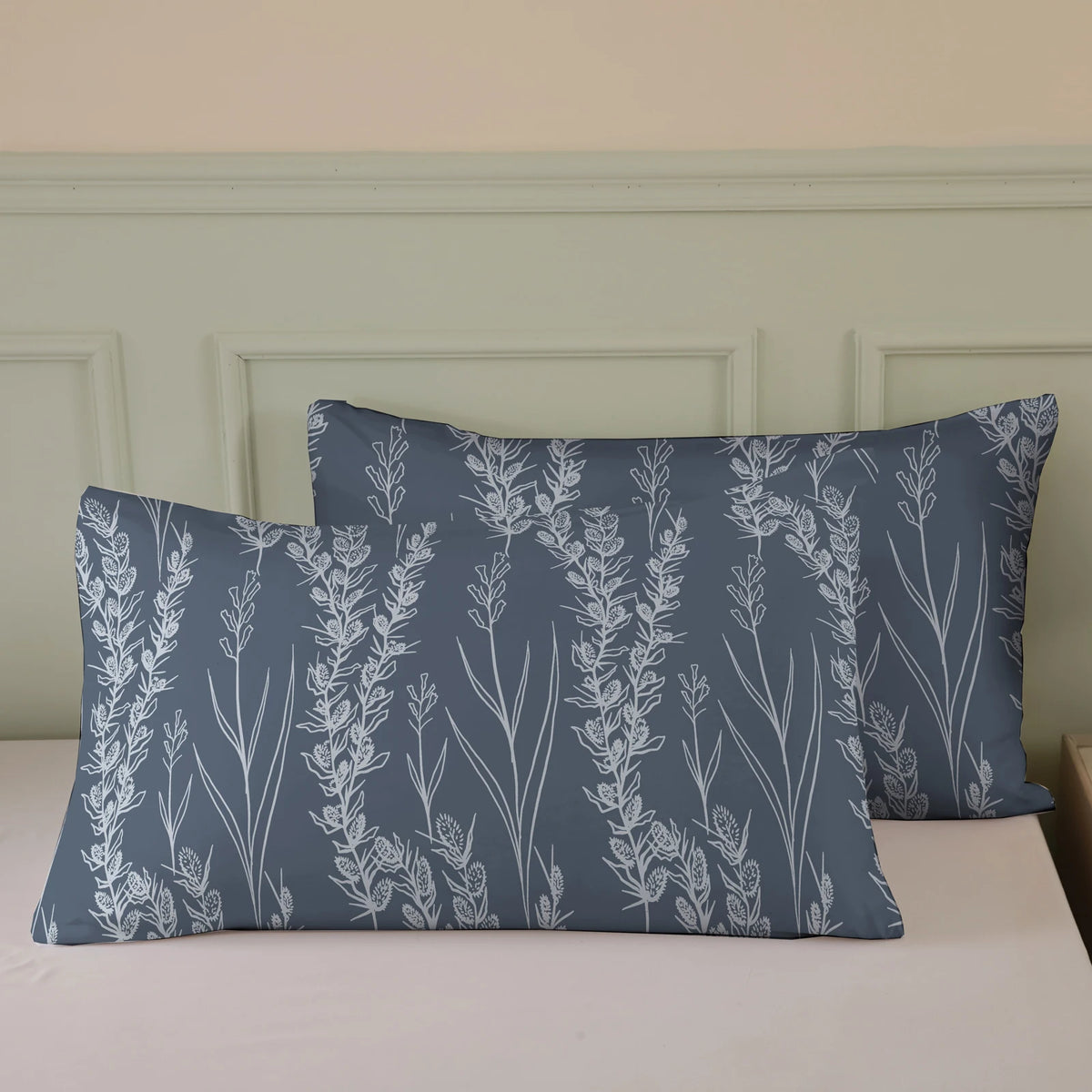 A set of three botanical print duvet covers and pillowcases in blue-gray with white floral designs.