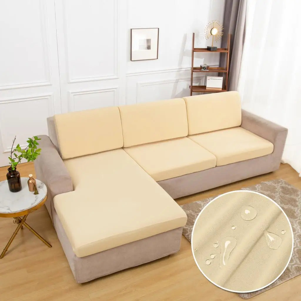A beige waterproof sofa cushion protector cover is displayed on a light gray sofa.