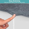 A hand is pressing a raised edge on a dark gray silicone drain mat to quickly drain water.