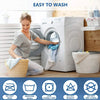 A woman is folding laundry near a white washing machine with various care symbols displayed.