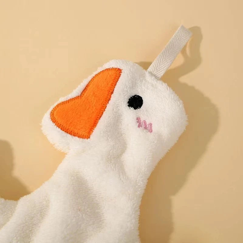 A white cartoon goose hanging hand towel with an orange beak and a light gray strap.