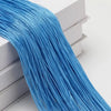 A bundle of bright blue thread used as a curtain tie-back for doors and windows.
