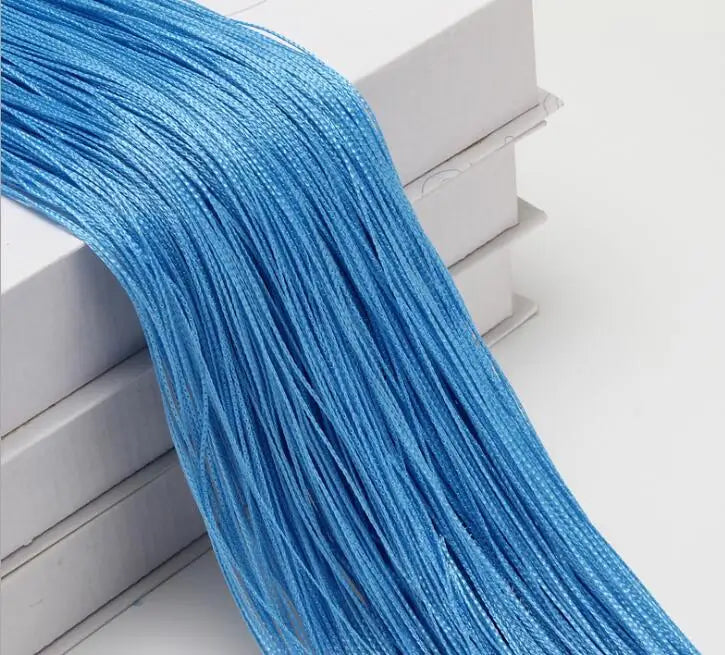 A bundle of bright blue thread used as a curtain tie-back for doors and windows.