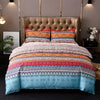A colorful boho geometric duvet cover set featuring intricate patterns in shades of orange, blue, and pink on a bed.