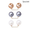 A set of three pearl-colored brooch jewelry items, including gold-toned findings.
