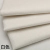 Stack of white coarse linen and cotton fabric rolls