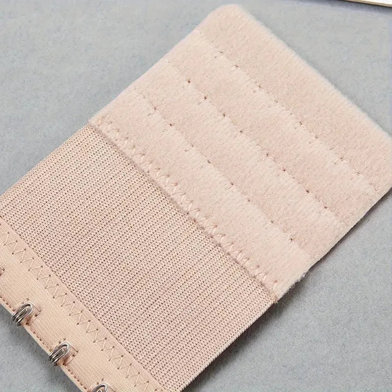 Light pink adjustable bra extenders with ribbed fabric and metal clasps