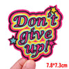 Pink letter embroidered iron-on patch with the text Don't give up!