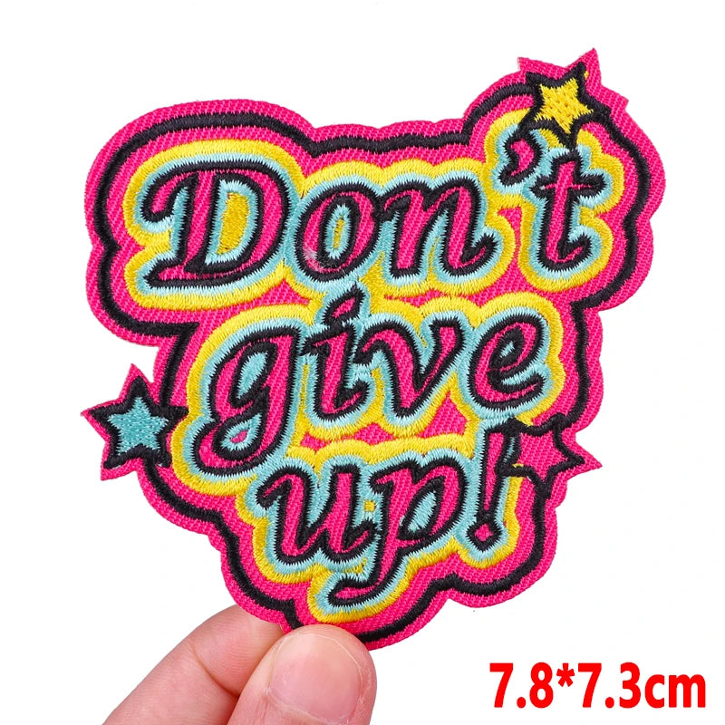 Pink letter embroidered iron-on patch with the text Don't give up!