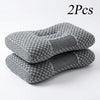 Two gray ergonomic contour pillows designed for neck and shoulder support