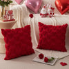 A set of red heart embroidery plush cushions and a pink heart balloon on a white textured fabric.