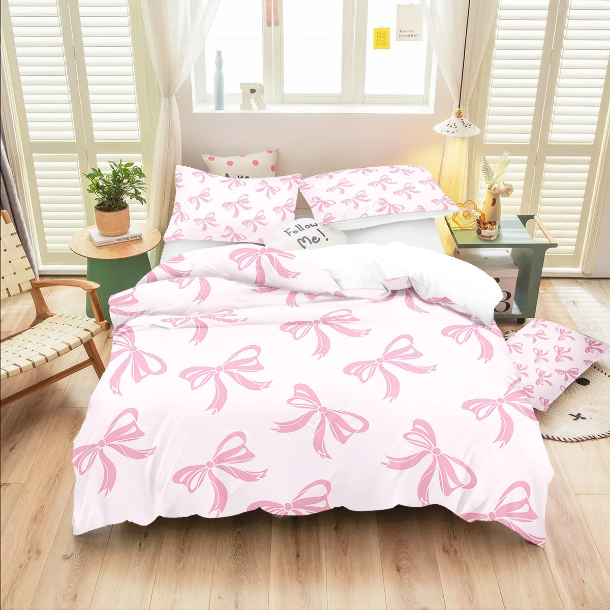 Pink butterfly pattern bedding set featuring a quilt and pillowcases on a bed.
