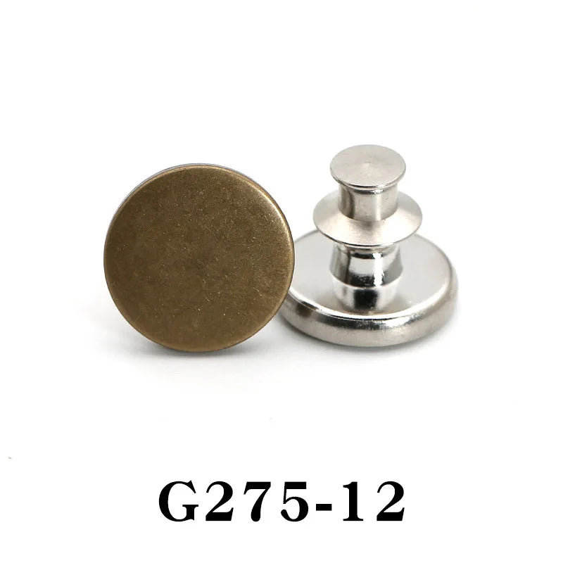 A round, brass-colored button pin with a silver post and cap.