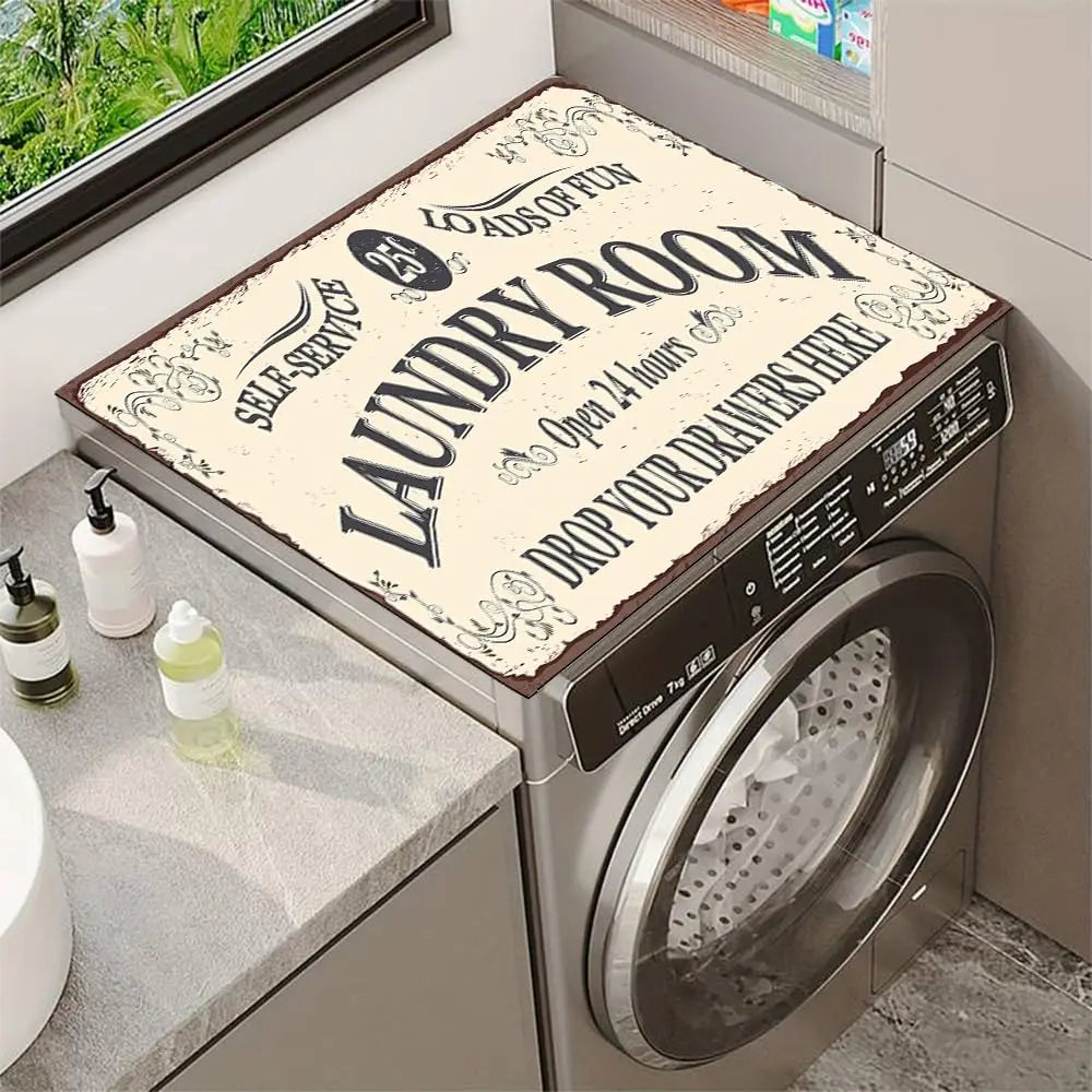 A close-up view of a stainless steel laundry room appliance with a decorative sign on the lid.