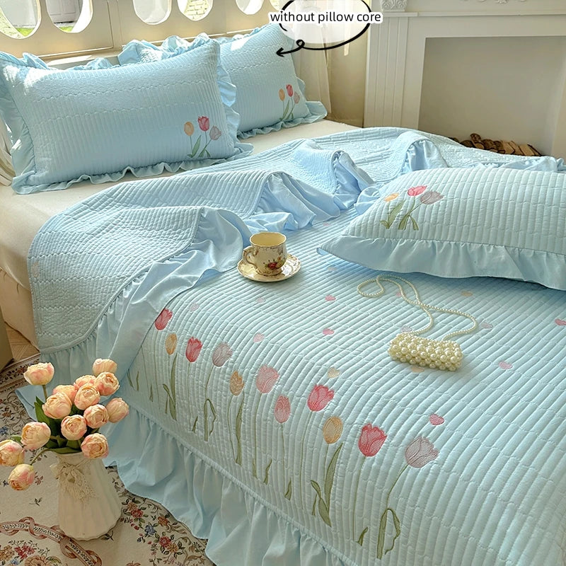 Light blue embroidered floral quilt bedding set with pink and green accents